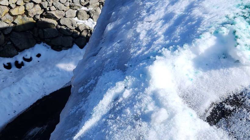 Ice dam on a roof edge in West Roxbury before steam removal
