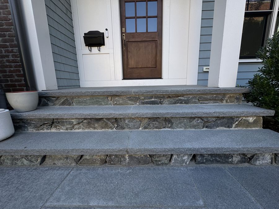 Granite front steps with fieldstone risers in Brookline