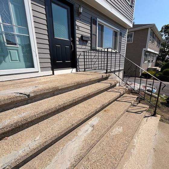 Before: worn and patched concrete front steps on a Dorchester two-family