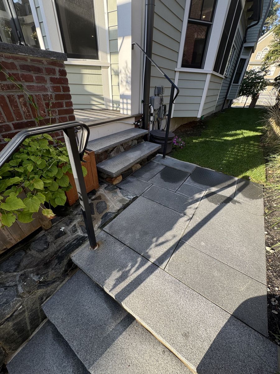 Granite paver walkway and rear steps with iron railing in Brookline