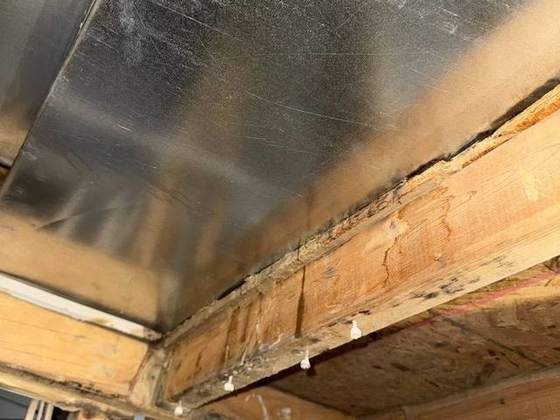 Water staining on framing behind ductwork found during a water damage inspection