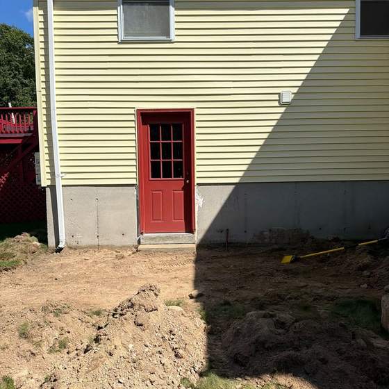 Before: side door with no walkway, bare ground