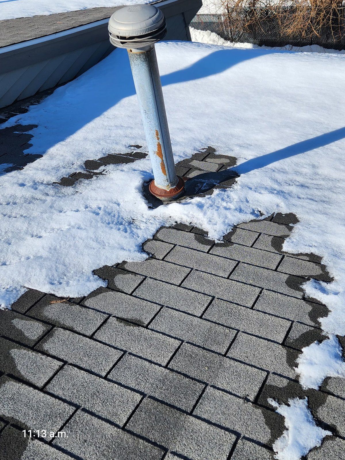 Patchy snowmelt pattern on West Roxbury MA roof showing uneven attic insulation causing ice dams — diagnosed by SR Enterprises